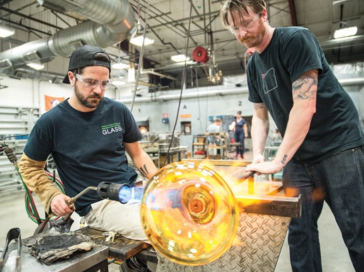 Professor and students glass blowing