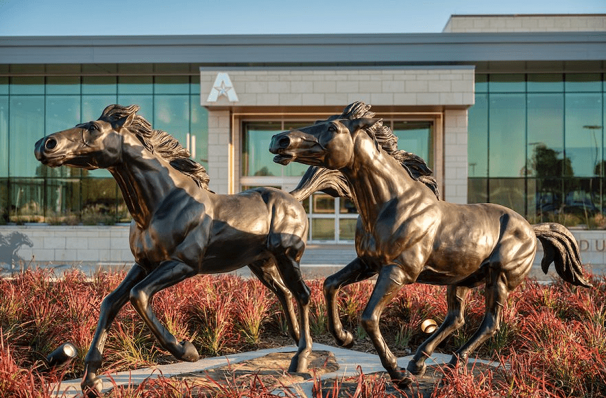 two statues in front of UC entrance