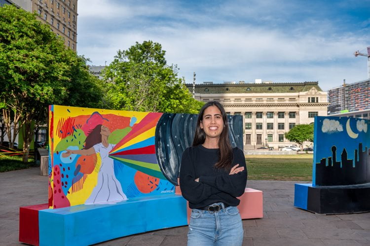 Angeles Margarida with her public art project, which was inspired by her service-learning experience in Tanzania