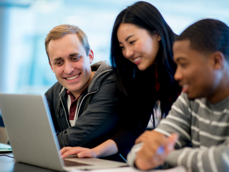 students gathered around computer