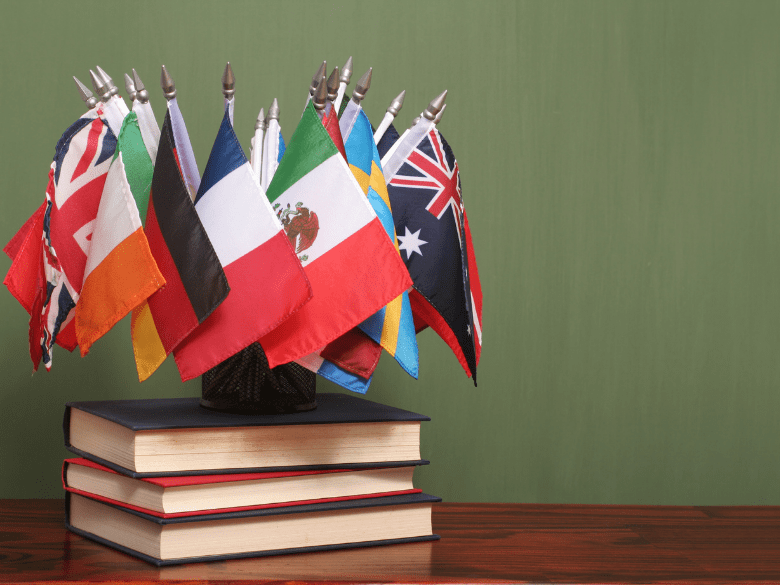 International flags on stack of books