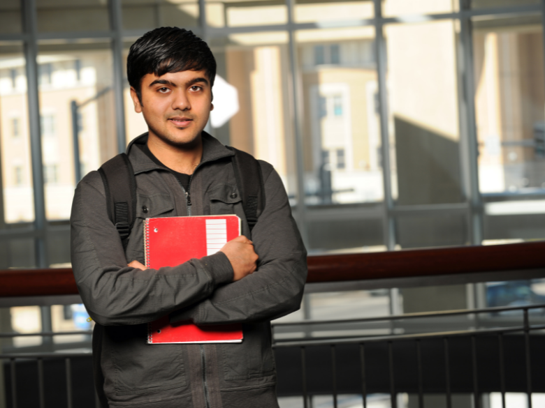 student holding book