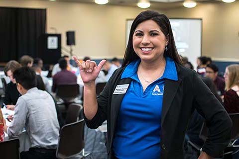 woman doing mavs up hand sign