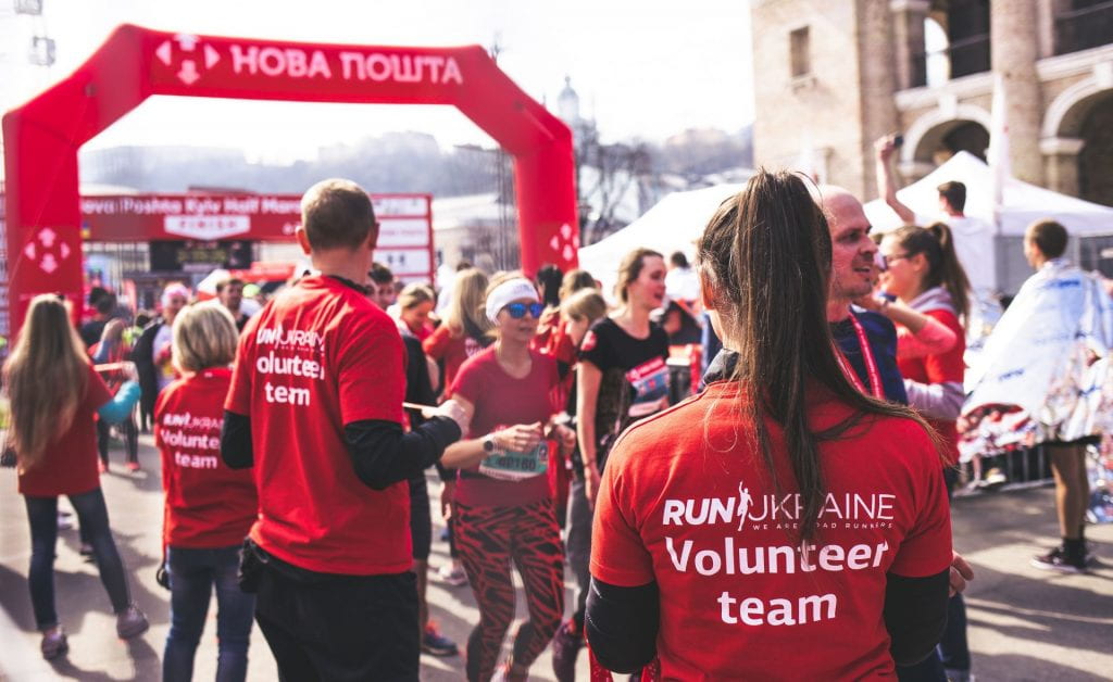 volunteers cheering on runners in a run