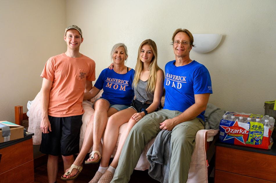 Parents posing during UTA Move-in day with their son and daughter