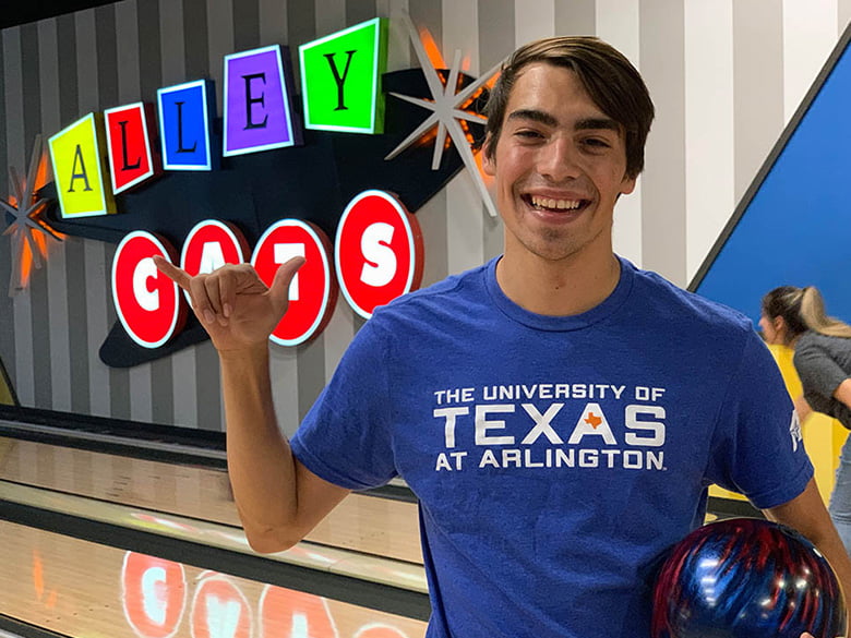 Student bowling at Alley Cats