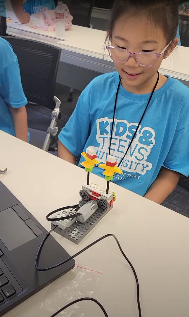 Girl building mini robot