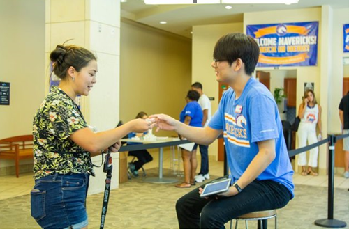 move-in volunteer being handed a sign in document