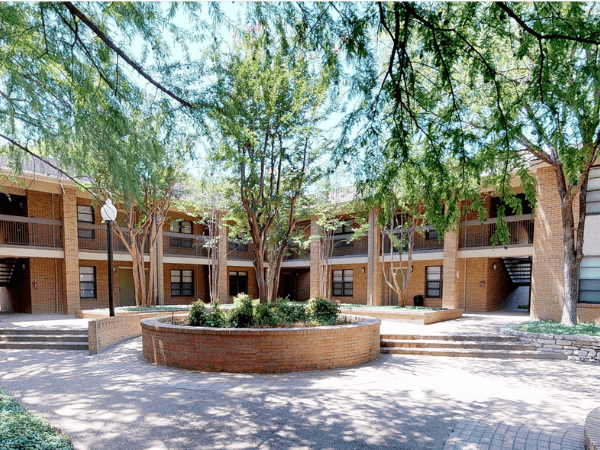 University Village Apartments Exterior with circular entrance and trees