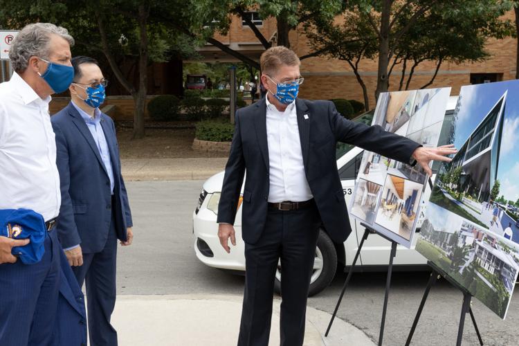 UT System Chancellor James Milliken, left, interim President Teik Lim, center and John Hall, vice president for Administration and Campus Operations look over renderings during a campus tour Aug. 17 in Arlington.