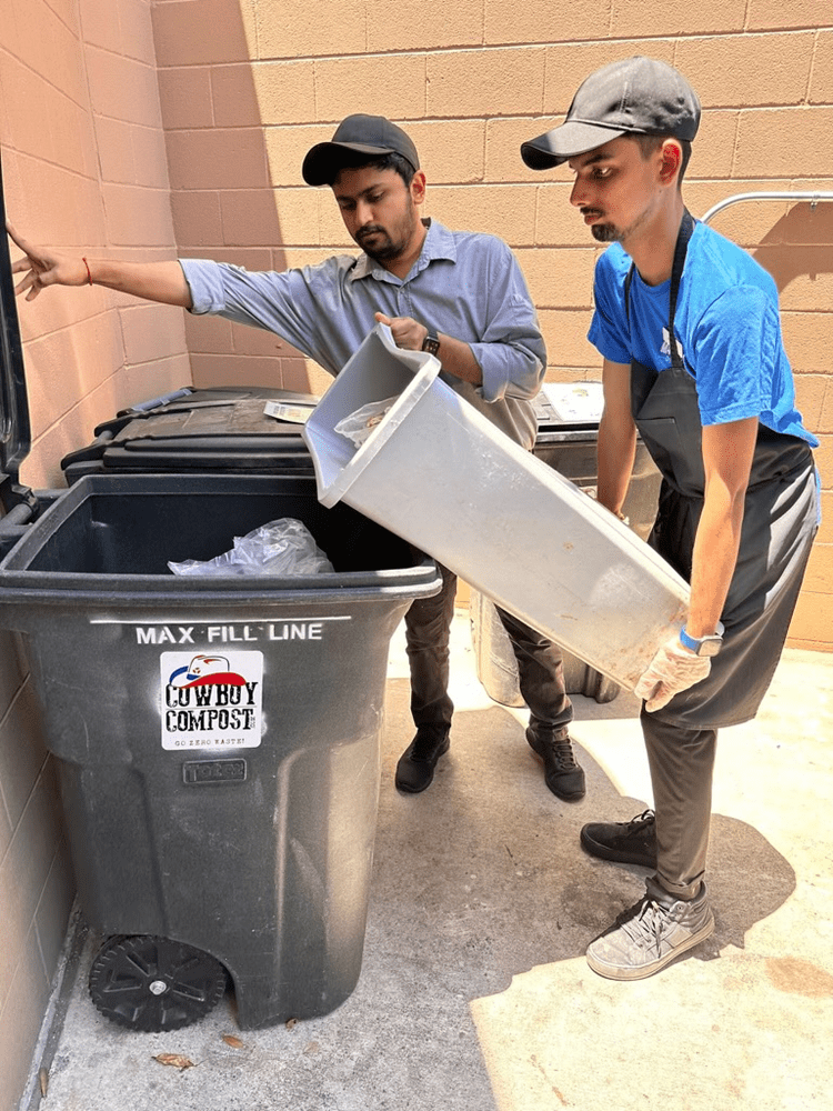 Students emptying compost bin