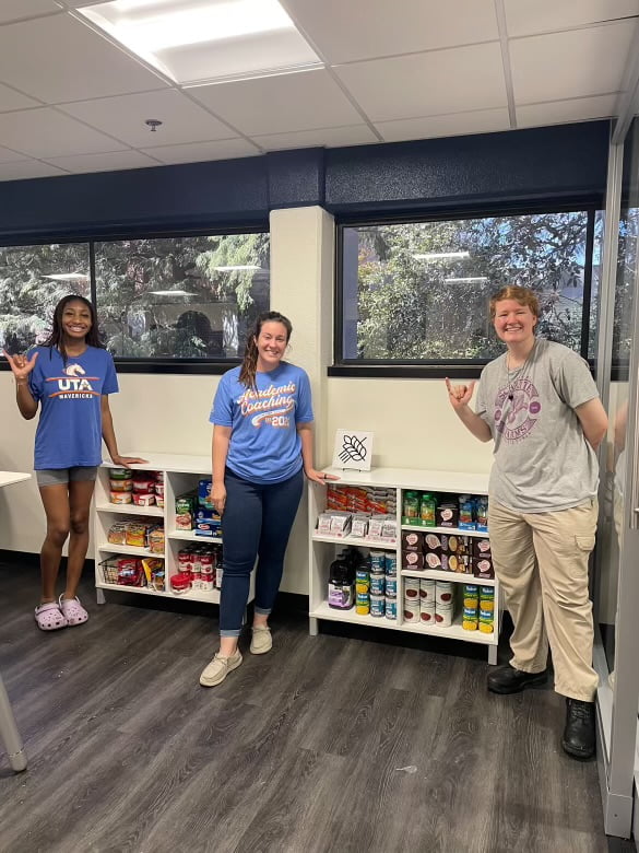Students by pantry shelves
