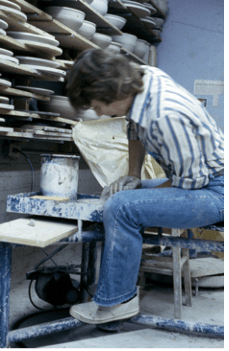 A student working hard at a ceramics project