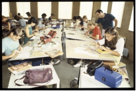A photo of young students working on art projects
