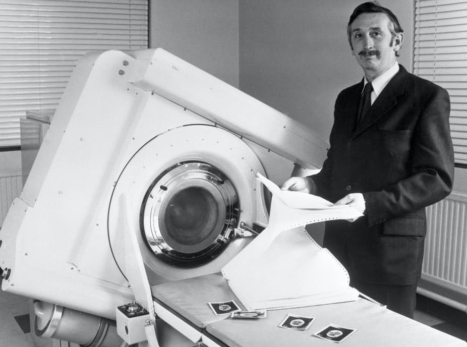Godfrey Hounsfield stands beside the EMI-Scanner in 1972