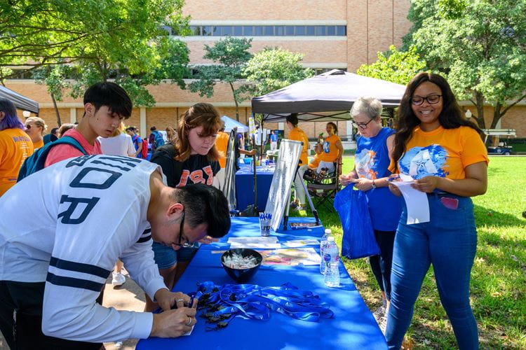 Students interacting at a table during a CoLA event