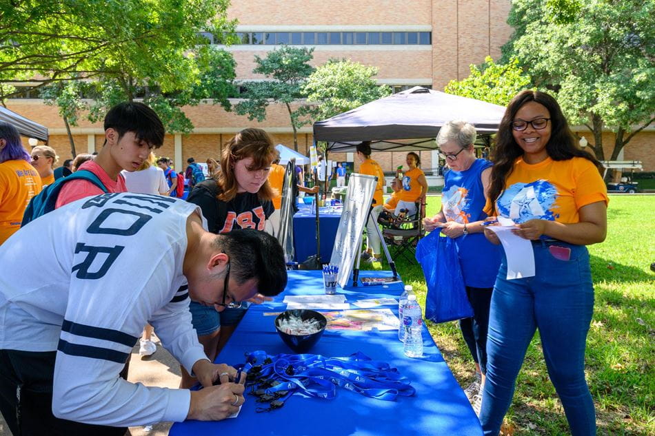 student visiting booths at a campus event