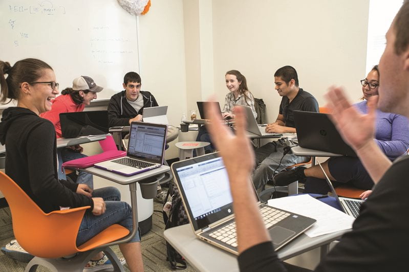 students engaged in a conversation, seated in a circle