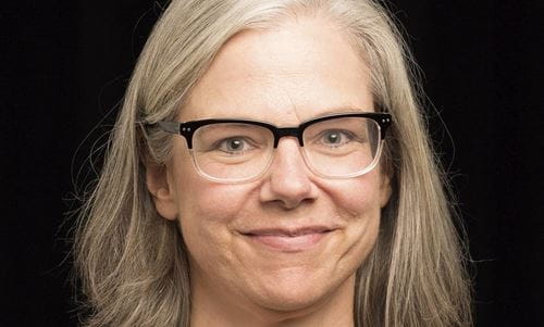 Dr. Jeanmarie Higgins wearing glasses, smiling