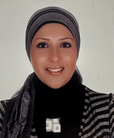 Mira Fakhran's smiling, wearing a striped sweater and a hijab.