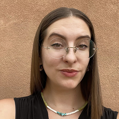 Kelsey Hanson smiling with glasses and long hair
