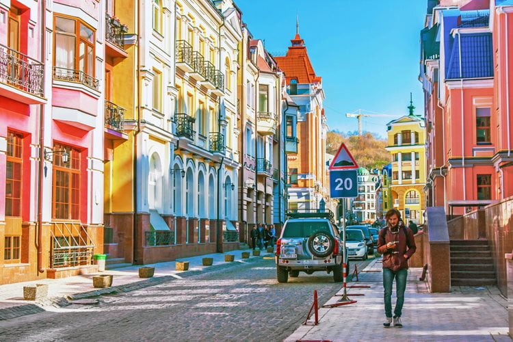 Person walking through colorful city street