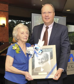 Betty Ruch, left, and Pat McDowell pose with a portrait of McDowell's father, Charles, at a 2010 reception.