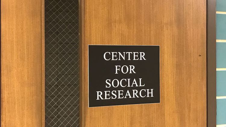 An image of a door with a board named Center for Social research