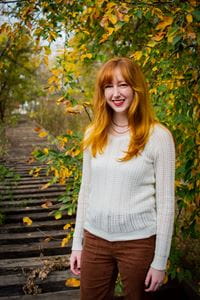 Lauren Vanpool posing in front of trees, smiling