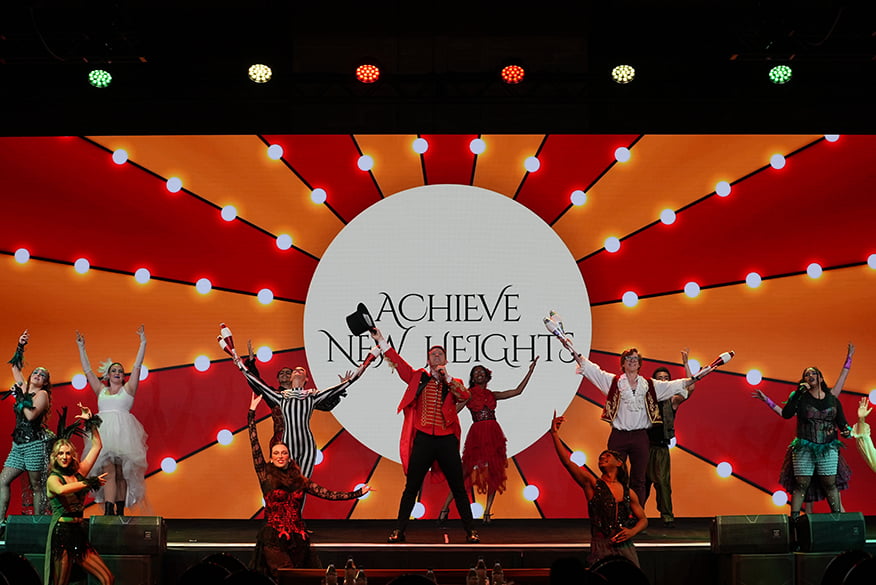 Performers on stage in circus attire.