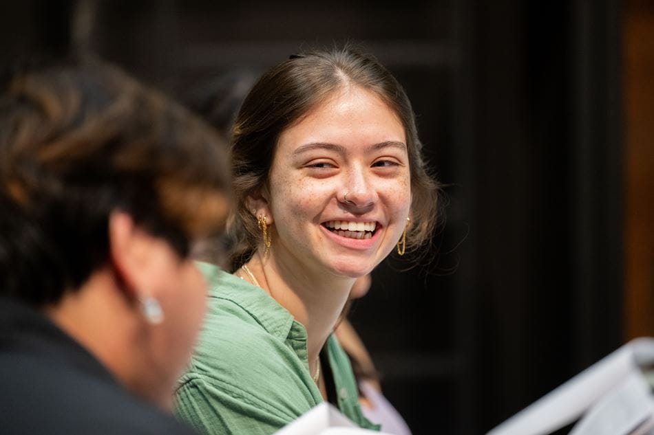 Student Smiling at the Camera Holding a Play