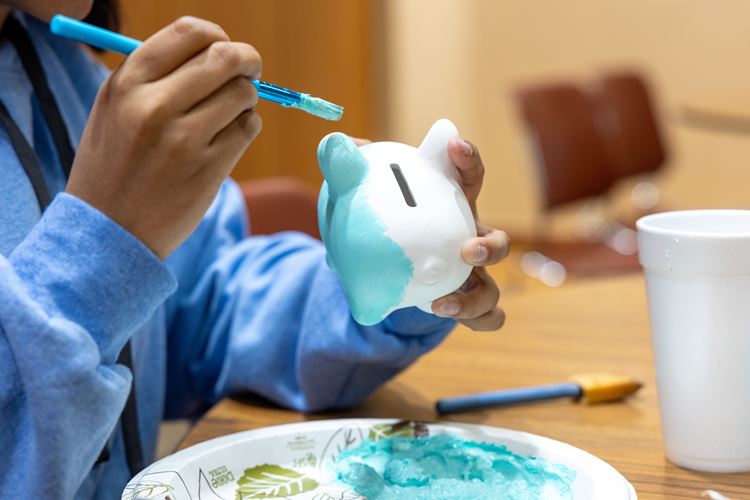 Student paints a piggy bank