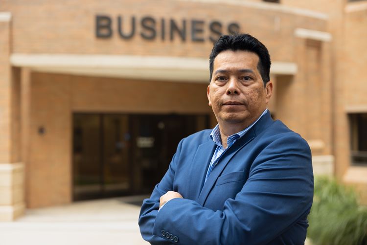 Oswaldo Ortiz Sr. stands in front of the College of Business at the University of Texas at Arlington on May 31, 2024. 