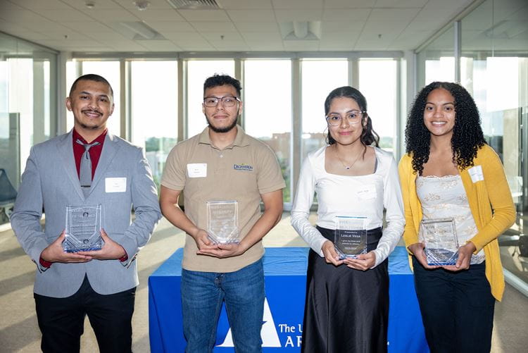 Juan Gonzalez (Left), Bryan Velasquez-Sanchez (Middle-left), Leslie Vega (Middle-right), and Anesah Collier (Right) pose for a photo after receiving awards during the RISE Academy ‘Evening of Impact” event at the University of Texas at Arlington Library on May 16, 2024