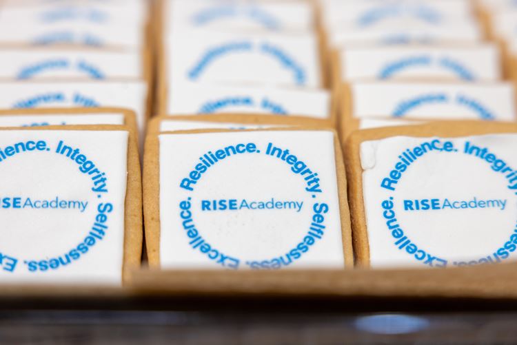 Cookies adorned with the RISE Academy logo sit for attendees at the RISE Academy ‘Evening of Impact” event at the University of Texas at Arlington Library on May 16, 2024. 