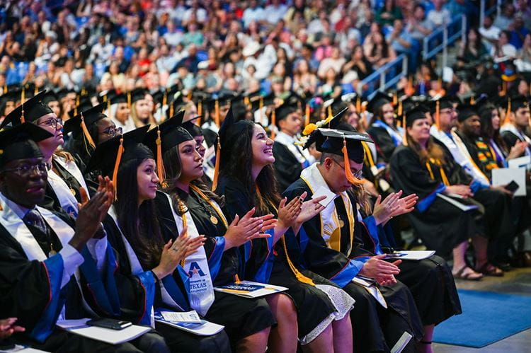 graduating students sitting in the cpc during a commencement ceremony