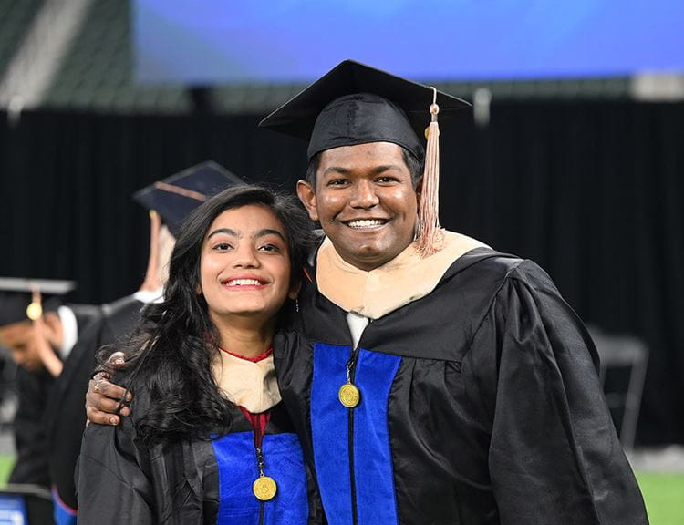 male and female graduates at uta engineering commencement in arlington