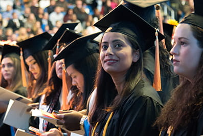 Row of students wearing caps and gowns during a commencement ceremony