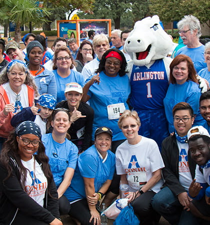 A group of students and faculty pose with Blaze before the 5 K run.