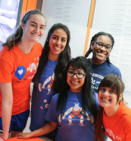 A group of five students smile at the Healthcare Professionals rally.