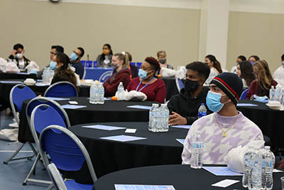 student attendees sitting at tables at BSPH conference