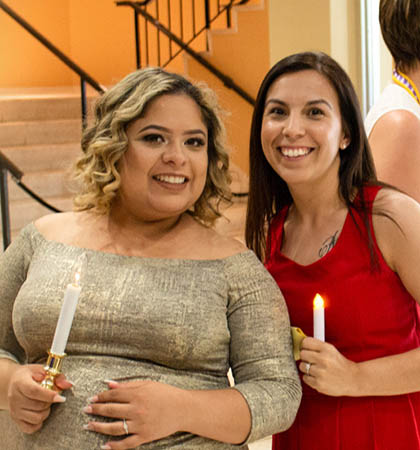 2 girls holding candles