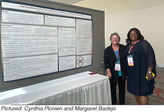 Cynthia Plonien and Margaret Badejo standing next to presentation board