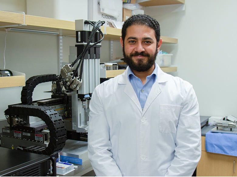 portrait of Kamal Awad standin in laboratory