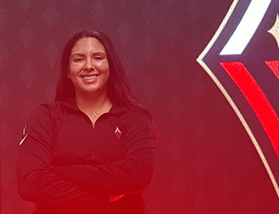 Clarissa Lopez posing in front of the WNBA Championship logo