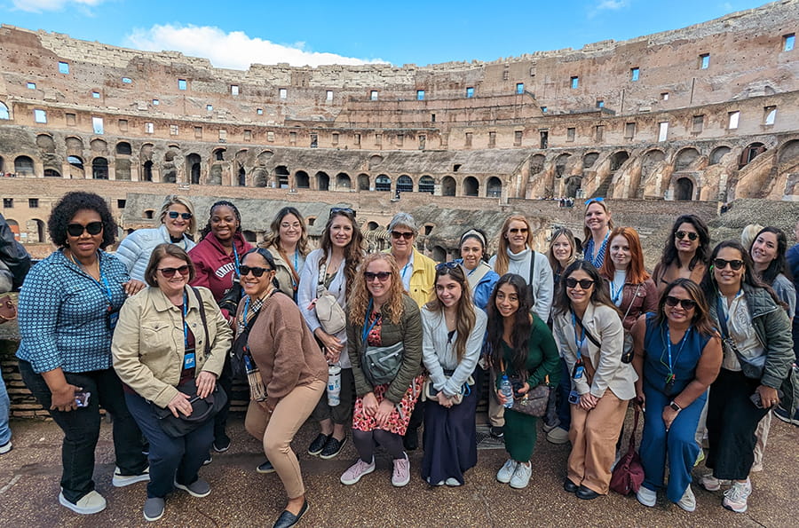 Nursing students in Italy standing in front of the Colosseum