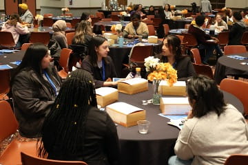 room of students sitting at tables at public health seminar