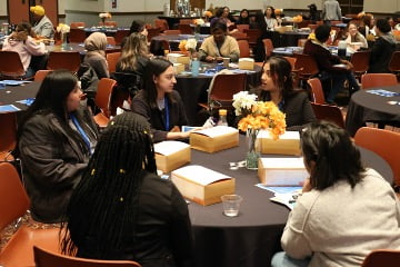 room of students sitting at tables at public health seminar