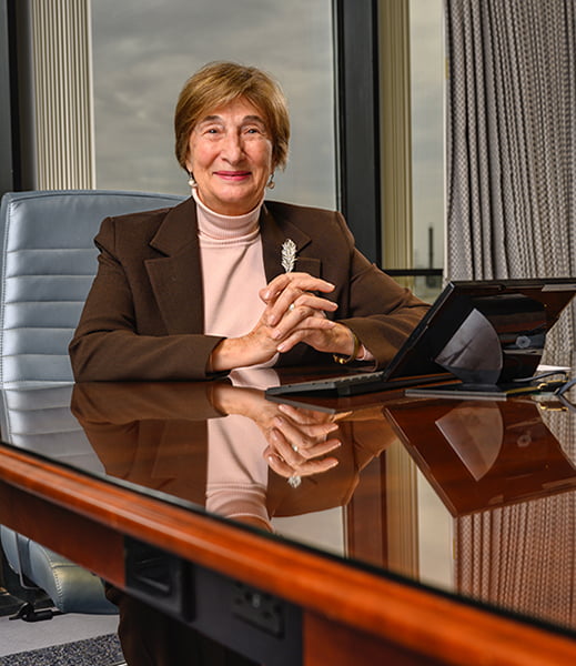 portrait of Marion Ball seated at table with laptop