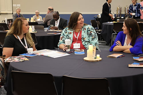 Rural Health Attendees sitting at tables and chatting